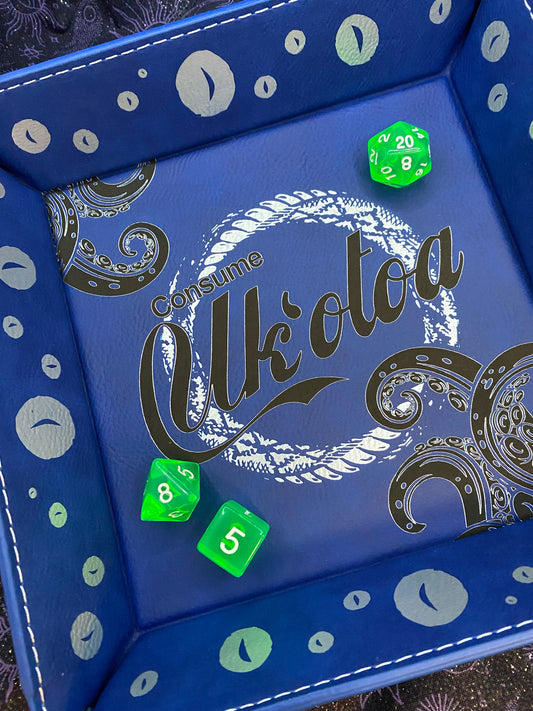 Blue leather dice tray featuring 'Consume Uk'otoa' design with tentacles and sea motifs, inspired by Critical Role's sea monster character, surrounded by green D&D dice